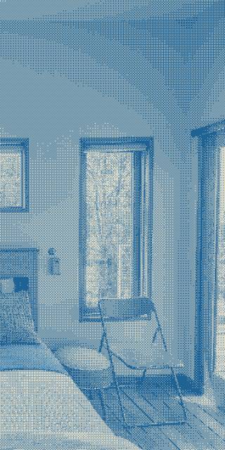 Chairs and a side table rest in the queen bedroom.